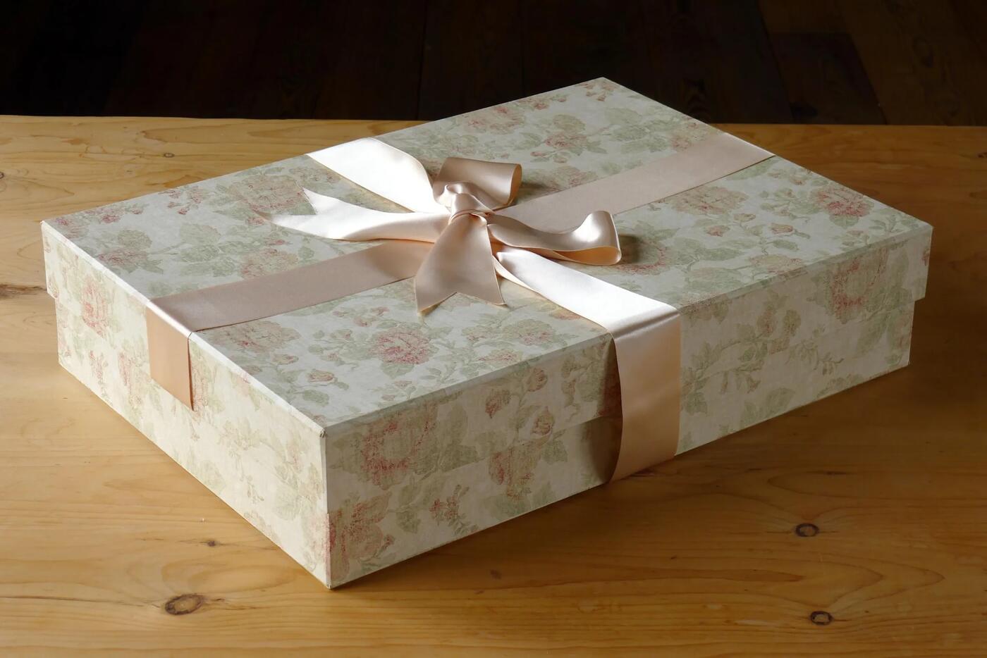 Handmade floral preservation box tied with a blush satin ribbon