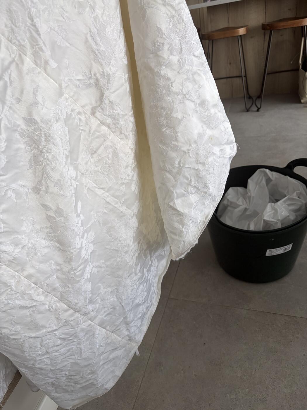 Clean ivory skirt of a restored antique jacquard wedding dress